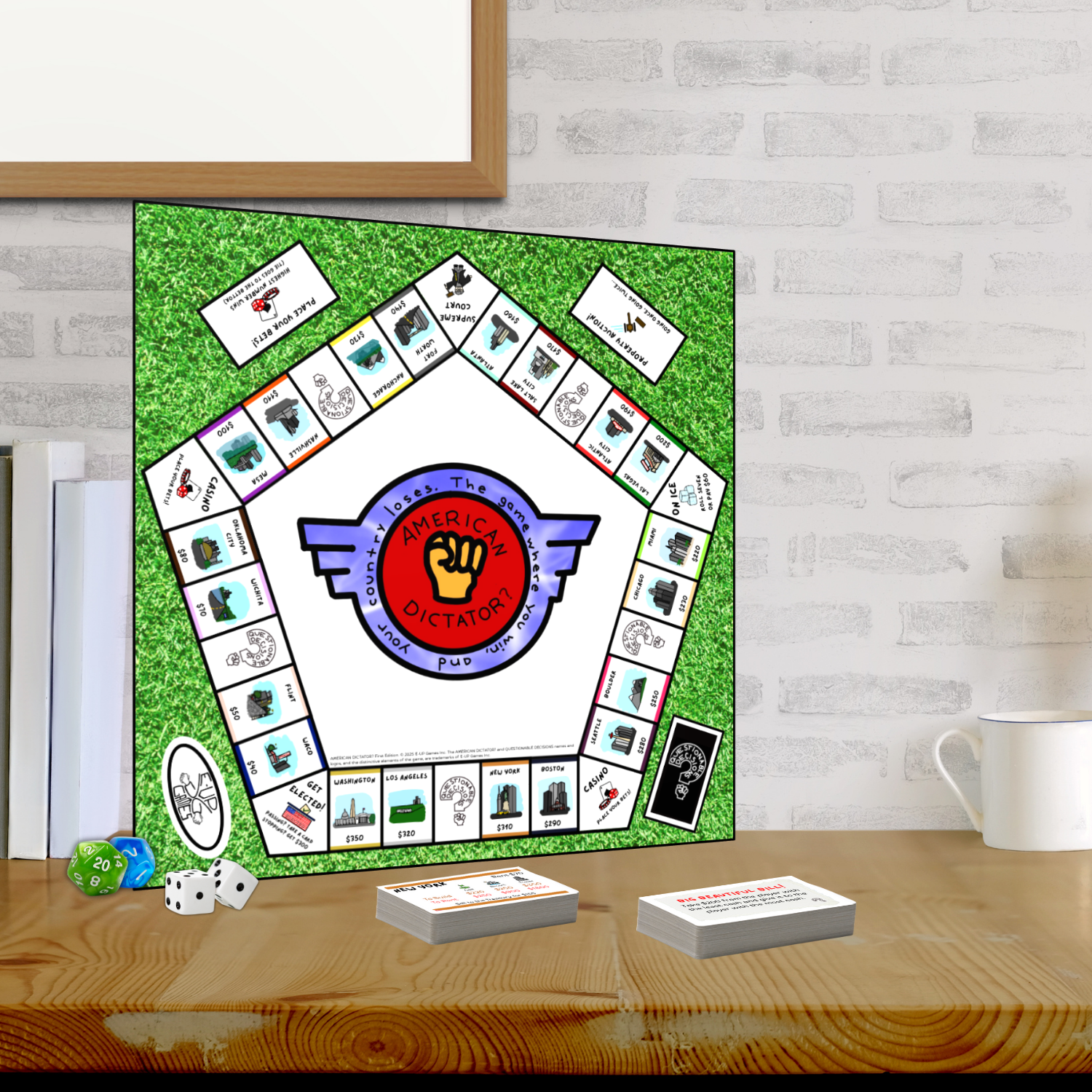 AMERICAN DICTATOR? board game with cards and dice on a wooden table against a white brick wall.